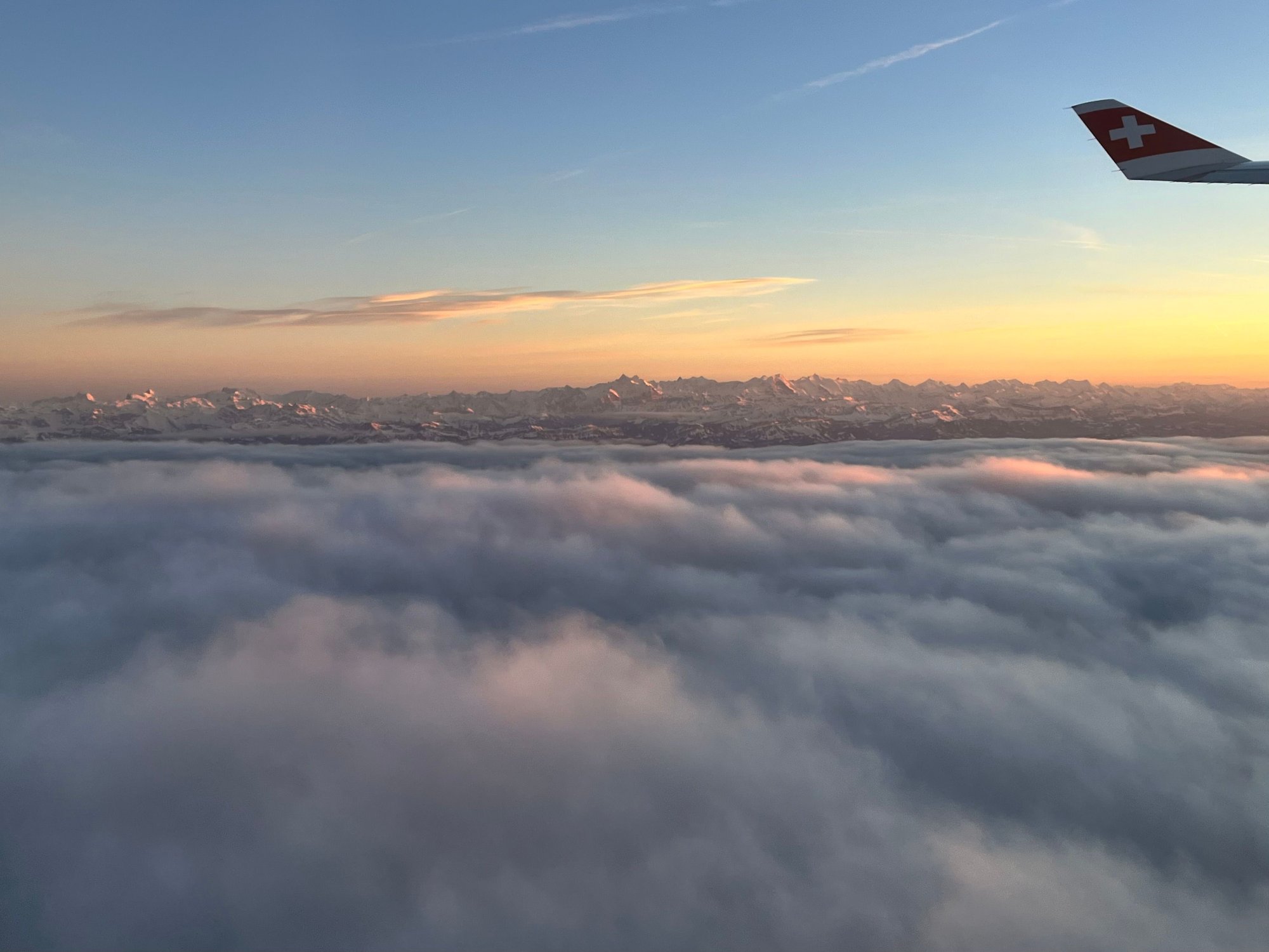 Soon after takeoff from Zurich; love seeing the Alps peeking above the clouds
