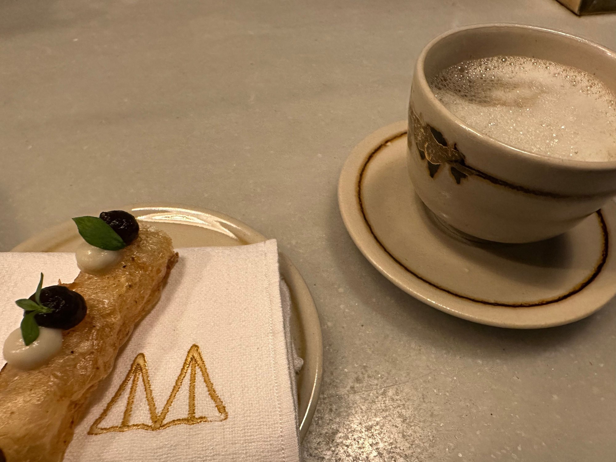 Amuse at MONT BAR.  Mil hojas multi layered pastry with creams of mushrooms and of artichoke. Eat this first, follow with consomme of mushrooms and Bordier butter.   