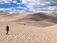 Joyce filling her shoes up with sand.