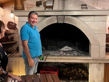 Veal, potatoes, and veggies cooked under an iron bell