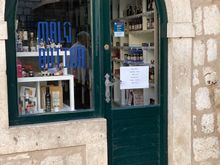 This was a style of door to keep an eye on shoplifters.  The proprietor could open the door on the right and put a counter board across so he could do business without people coming into his store.