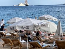 You can rent these chairs or sit on the beach.  You can see two ships in the back, one is a cruise and we found out from a guest at Villa Gloria, that it was their boat for a National Geographic cruise.