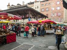 The weekly market. The candied kumquats sold here blew our minds and pleased our dentist. Note row of bras just under awning to raise awareness of breast cancer.