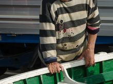 This Ischian and his mates were moving their freshly-painted boats out from shore for the first time since winter.