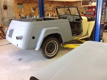 Half primed and probably my last view of the butter yellow paint. DH wants dark red with cream trim.