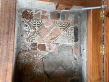 As you walk along you come upon two or three little doors in the grass. When opened you can see some of the original floor