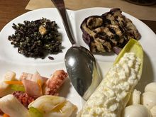 One of FOUR plates comprising the mixed antipasti...octopus salad; black rice salad; grilled eggplant; endive stuffed with ricotta; burrata; and mozzarella knots