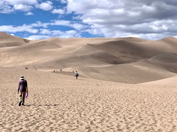 Joyce filling her shoes up with sand.