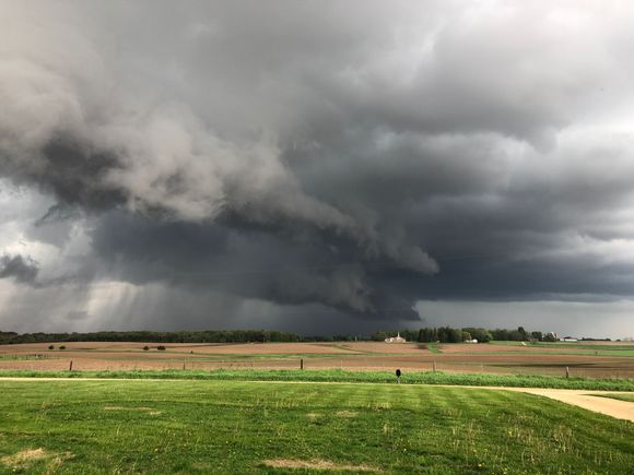 The view from my brother’s front porch this afternoon. I live right by the darkest of those dark clouds. At least there were no funnels in that sky!