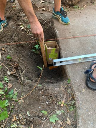 No small sonotubes for concrete anywhere so we dig through a huge pile of cardboard recycling for wine boxes.  The ingenuity!  