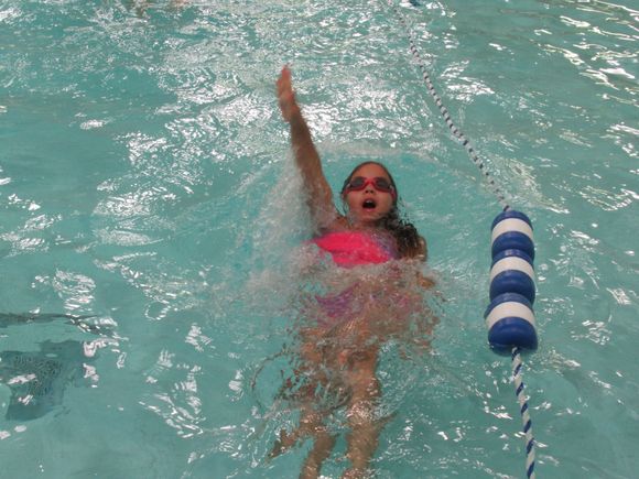 Doing the back stroke  and she  did it well...across the length of  the pool.

That's my girl ((L))