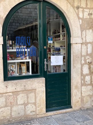 This was a style of door to keep an eye on shoplifters.  The proprietor could open the door on the right and put a counter board across so he could do business without people coming into his store.
