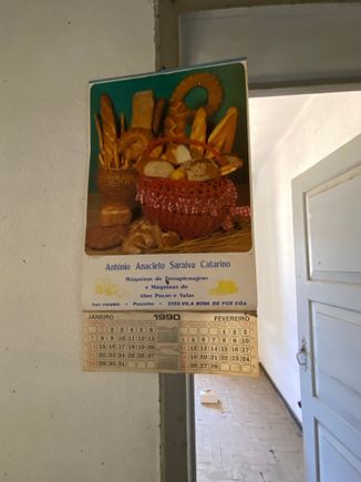 A 1990 calendar hanging in an abandoned building