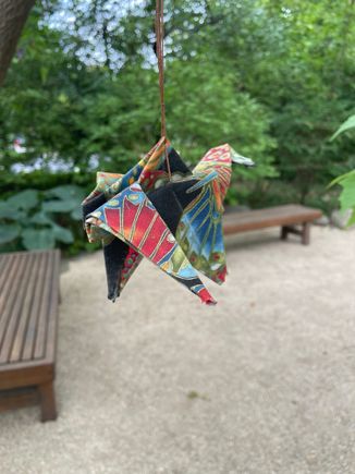 A rare one of a kind bird. 
It’s a crane  hanging at my Japanese Gardens.
My friend made it. I don’t have the talent.  Legend is if you make 1000 of these in a year, a wish will come true. 