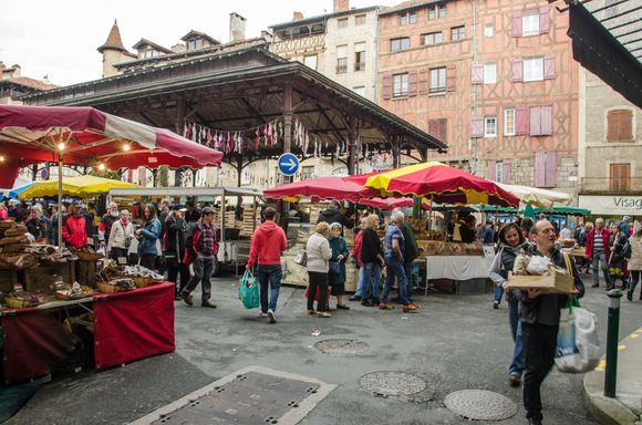 The weekly market. The candied kumquats sold here blew our minds and pleased our dentist. Note row of bras just under awning to raise awareness of breast cancer.