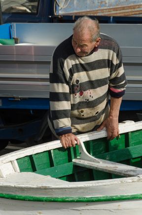This Ischian and his mates were moving their freshly-painted boats out from shore for the first time since winter.