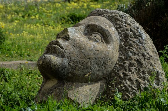 I highly recommend a stroll right up to the isle's highest point, the Terra Murata neighborhood. That summit is a quiet residential enclave, a genuine village. Go past the old cannons plus the large stone sculpture shown here.