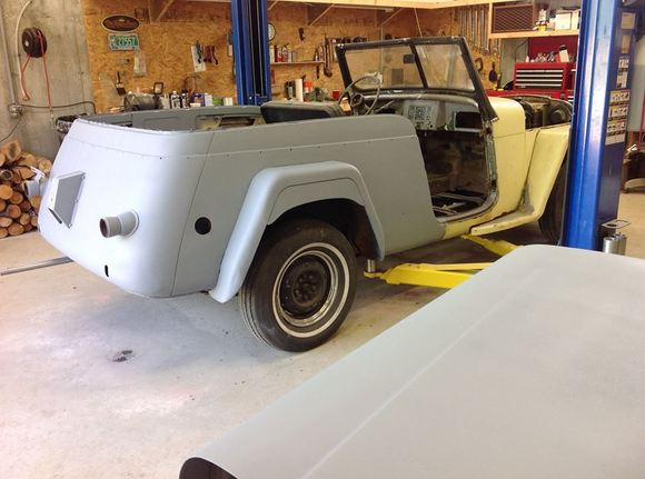 Half primed and probably my last view of the butter yellow paint. DH wants dark red with cream trim.