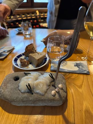 Raw veiras, a species of scallop, with the plate of excellent breads in rear.  