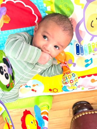 Kaleb has Leo to put his fingers in his mouth and tries to fit in a lot of them