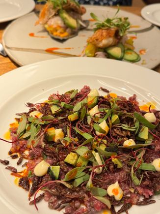 Beef carpaccio with grasshoppers, and a almost-finished fish tostada.