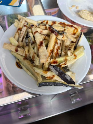 fried eggplant sticks drizzled with molasses