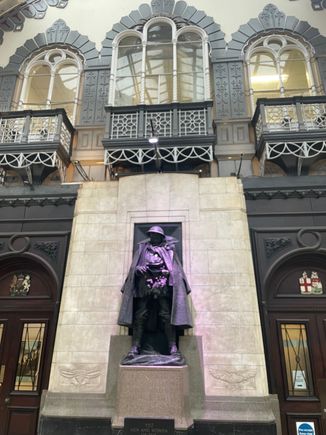 Statue inside Paddington commemorating some war