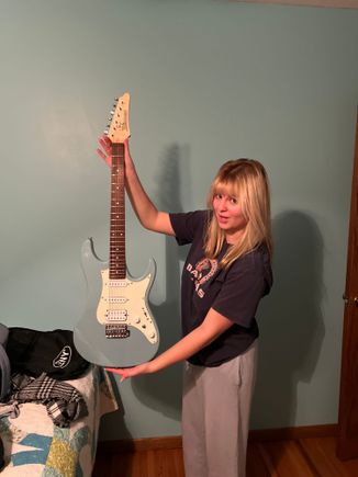 18 year old Chloe' with her guitar. She did a report on George Harrison and now is in a band.