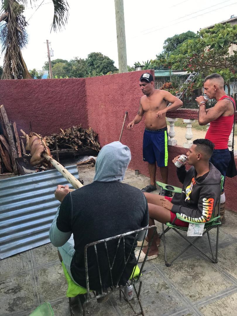 Me and my Cuban friends roasting the pig for 8+ hours in the front of our casa last New Years Eve. All of us enjoying lots of cervezas and ron too all day long, with other friends from the street dropping by for a chin-wag with the sweet aroma of that pork in the air. I'm not in the foto as I'm behind the camera. 