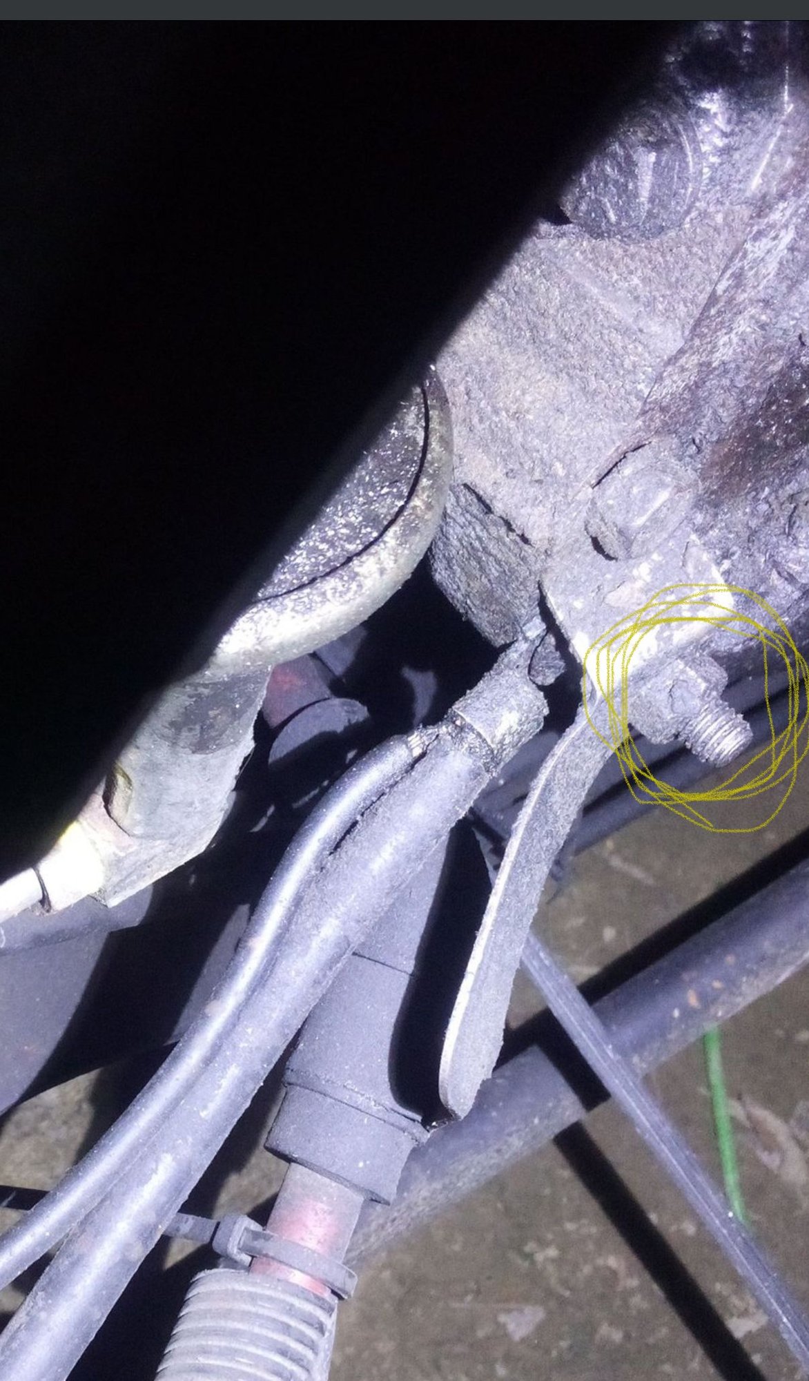 Yours seems to have a bolt and nut sticking out the bottom hole that curves around the negative cable.