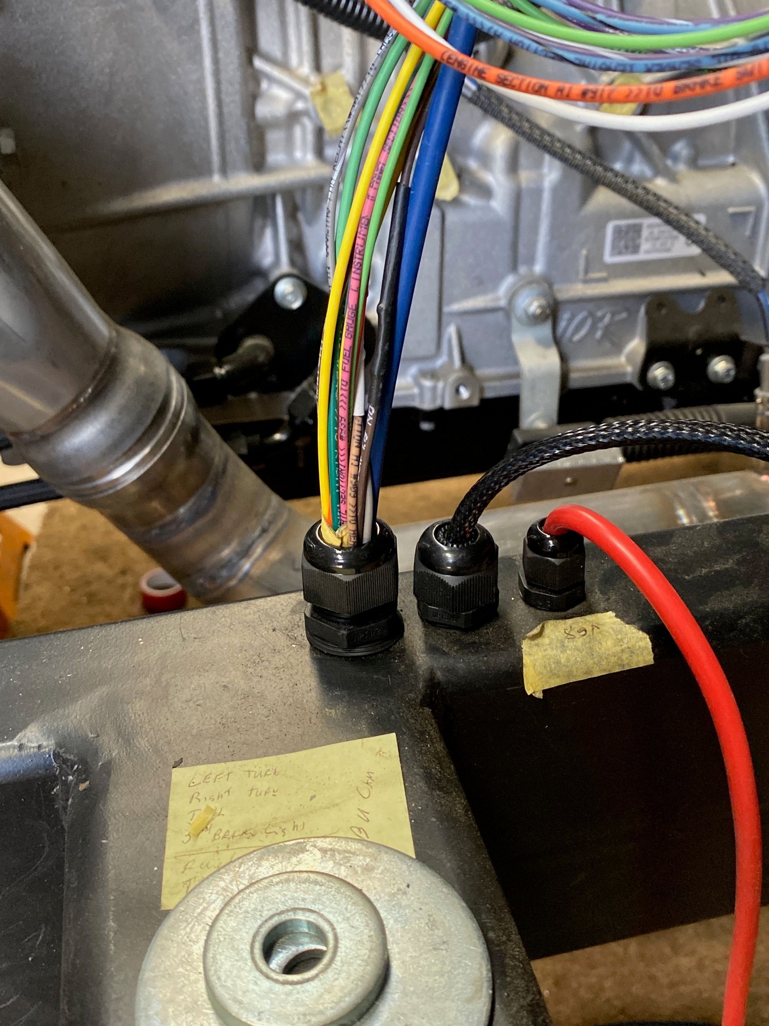 Wires coming out of or into frame rails. 