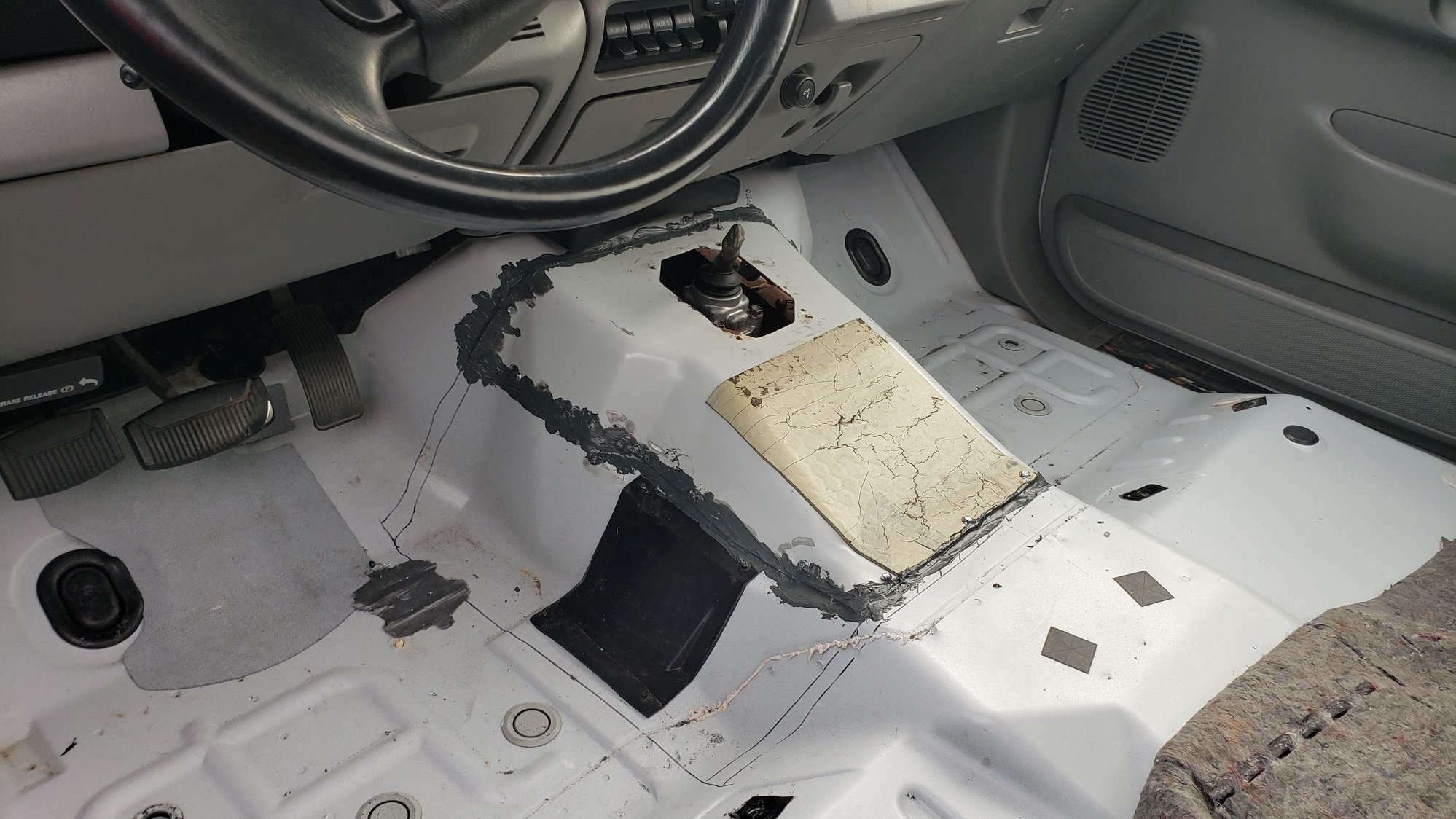 My less than stellar but totally sufficient sealing of the manual transmission tunnel cutout.