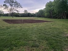 Started off with the tiller to chop everything up nice.  Stakes out in the grass are for the 24' addition.  Dirt to left of stakes are to keep from making to much of a "wall" idk...