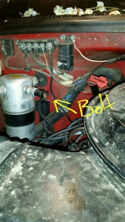 Here's the bizzare part. The hose that was connected to the "Purge" tube on my Bros truck, was instead plugged to a bolt on the wall. Doing nothing. Pretty much sealed. Hard to see since the background is red as well as it there is a red bolt coming out.