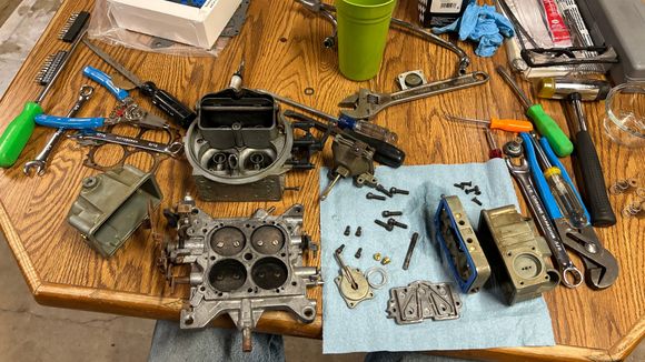 So I had the carburetor all tore apart. It went through a few cycles of the ultrasonic cleaner because I couldn’t fit it all in one go. And the bottom plate was just a little bit too big and it stuck up out of the solution so I had to flip it and then run it againwith a few other parts so it’s an old crusty carburetor, but it should work just fine. Throttle blades are a little bit rusty, and it took a while to get all the black carbon out of it. I didn’t get all of it, but I got most of it. 