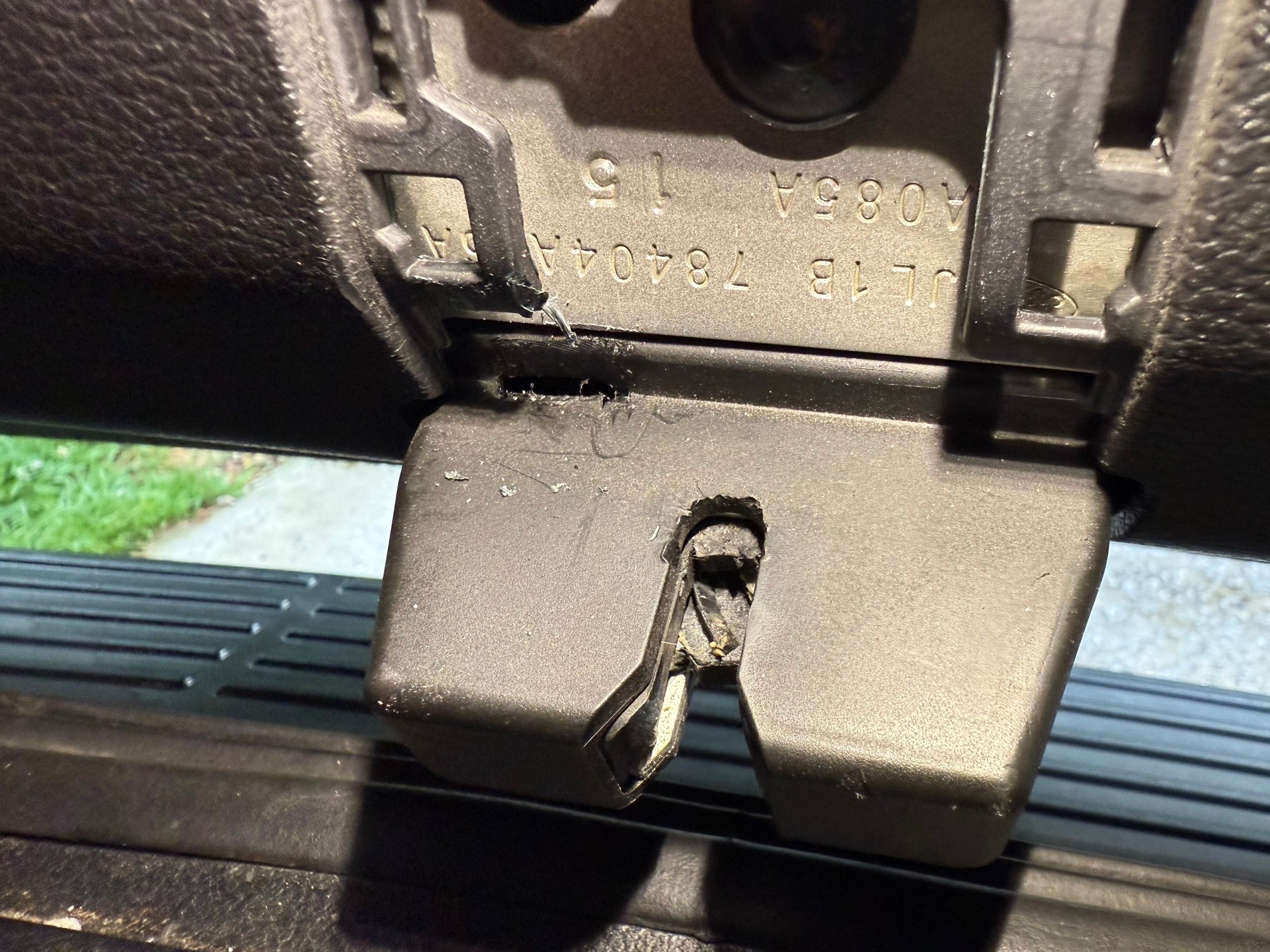 Look for the damaged area in my picture. There is a very small slit in the plastic. Shove the screwdriver or pick preferably down then push left. 