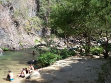 On the edge of a stream and mile high cliff.