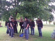 A wet riding group hiding under a tree waiting for the downpour to pass. After 15 mins we were on our way again!