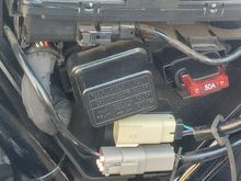 Under the left side cover are two plugs.  I'm told the white, unused one, is for the accessory switch. 