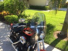 Trimmed about 1 1/4” off top o windshield using fine tooth sawsall blade and tool handle. I see over the shield now no problem. 