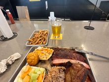 3 meat plate with fries, fruit and Mac and cheese.