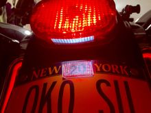 Aftermarket lens has white part facing downward.