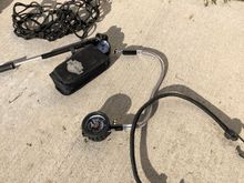 Shock pump, tire pressure gage, tool kit, tie down net