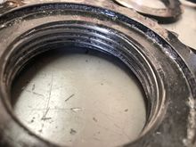 The threads are ground down. Probably the metal shavings I saw in the fluid