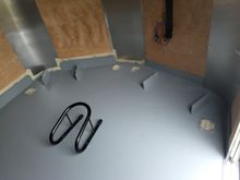 You can see the chock, the stock tie-downs along the sides, and the two extra tie-downs I added that both go through the front wheel spokes, protected by a towel, and some of the permanent cleats and other small tie-downs on the walls