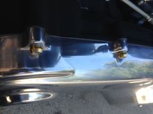 Brass compression fittings fit perfectly over engine and primary bolts, dab of superglue holds them perfectly.