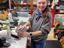 Morgan putting some leather conditioner on a heat shield before it goes in the mail.