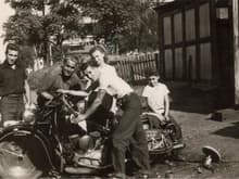 Gramps was a biker too! He's the one holding the handlebars. He just got done buffing this beauty after painting it. Funny we both prefer black &amp; chrome. This pic was taken shortly after WWII.