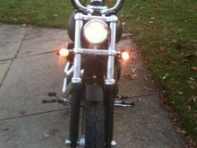 Front view lights on; High powered headlight bulb; smoked turn signals (relocated to forks); Fork lowers black powder coated; chrome axle covers