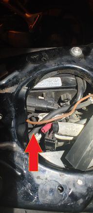 Red arrow pointing to black cable is audio harness.  Two wires split off and go to positive and negative on battery.  Brown cable is hanging free here under seat, no crimp or covering, wire looks clipped.